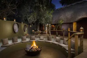 Swap stories of the day's sightings around the campfire at Ulusaba Safari Lodge.