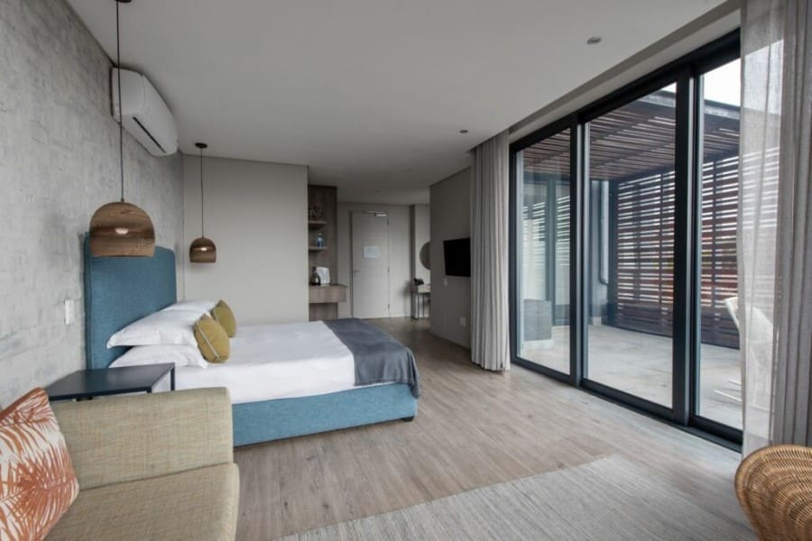 A spacious suite with sliding doors that lead to a private balcony. 