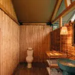 Though this is a bush camp, the en-suite bathrooms have flush toilets and hot showers.