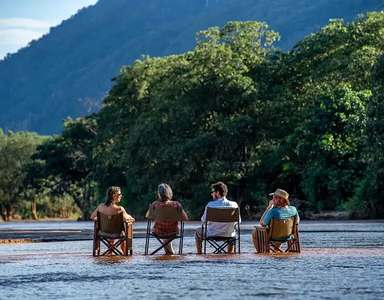 Drinks with you feet in the water, a special safari 'green season' experience. 