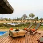 Relax next to the pool, enjoying the occasional splash between sips of fruity drinks.