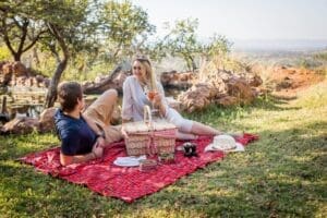 Book a romantic couples' picnic by a pond, frequently visited by birds, creating a soothing ambiance.