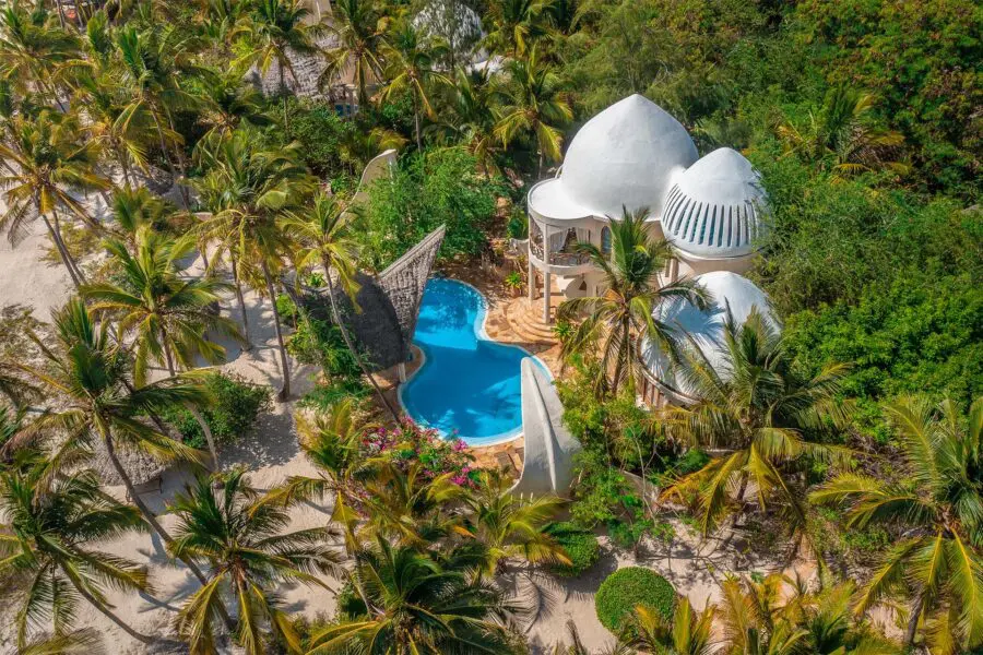 Birds-eye-view of Xanadu Villas' presidential ocean view villa, a stark white Arab-style villa with a gorgeously blu private pool on the beach surrounded by palm trees
