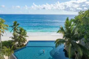 An infinity pool looks out over the beachfront, creating a stunning backdrop for photographs.
