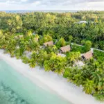 The Beach Bungalows along the palm-dotted coast of Alphonse Island.