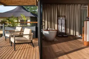 A free-standing bathtub next to a mesh window for lake views while you soak. 