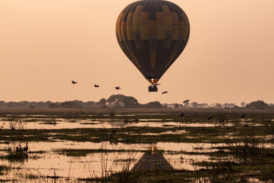 A hot air balloon drifts through Kafue at sunrise