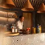 Order a drink from the bar.