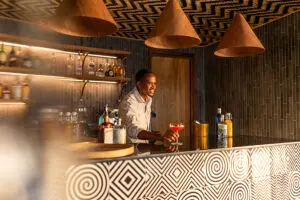 Order a drink from the bar.