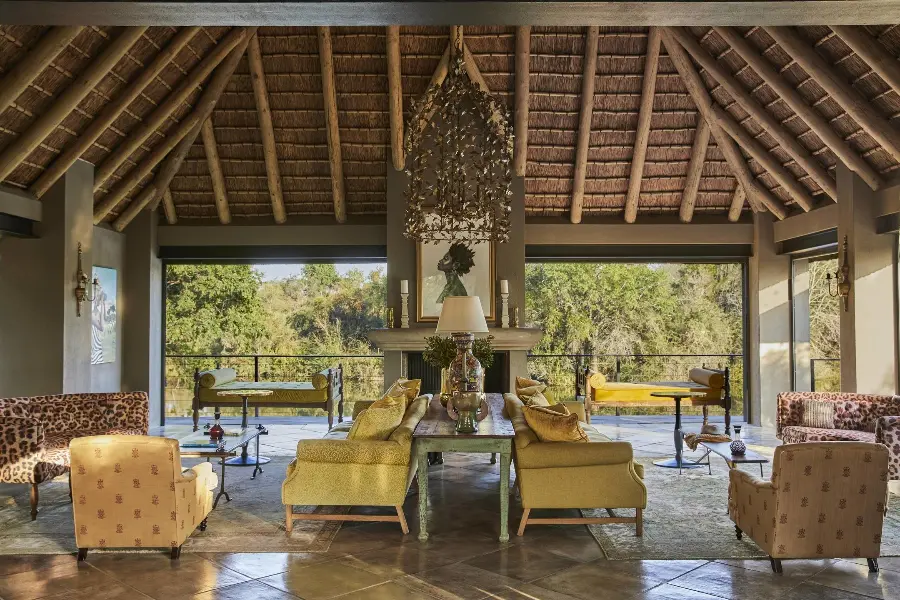 A symmetrical lounge with an open back wall complete with balcony and thatched roof | Go2Africa
