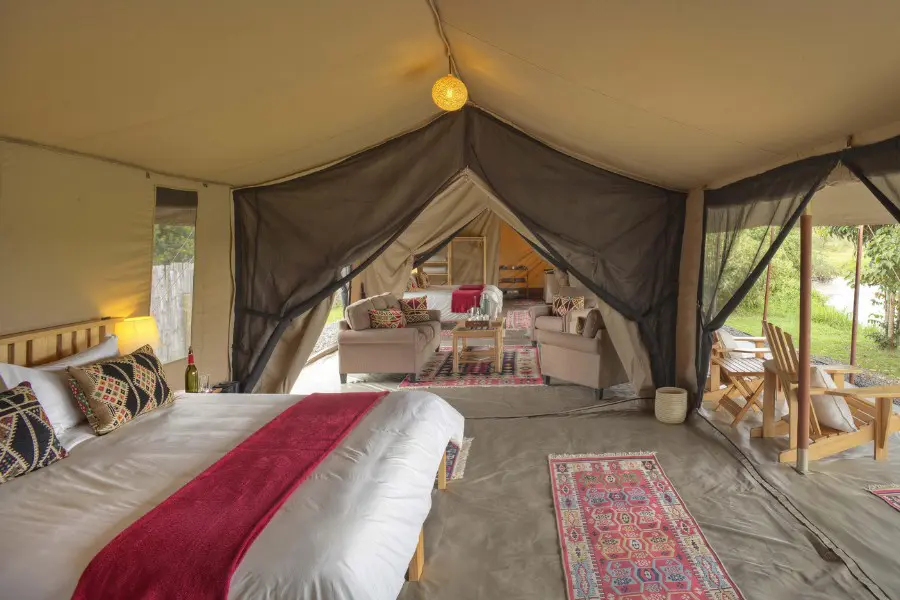 An open-sided canvas tent interior at Ol Pejeta Bush Camp, with views into the surrounding Laikipia bush | Go2Africa