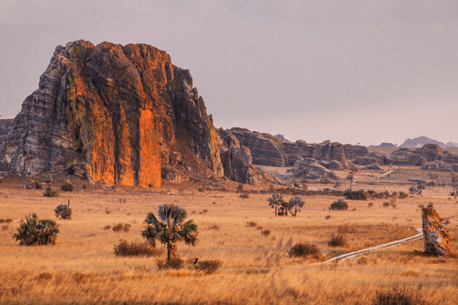 Rock formations rising from dry grassland in Isalo National Park, Madagascar | Go2Africa
