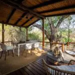 Relax on the spacious deck overlooking the bush below. 