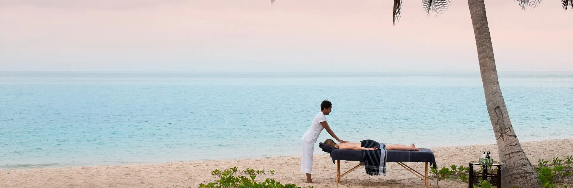 Guest enjoying a beachfront massage at Benguerra Island | Go2Africa