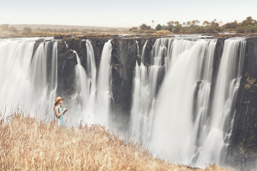 A woman pictured walking along the banks of Victoria Falls | Go2Africa
