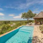 Cool off with a dip in the swimming pool overlooking the bush.