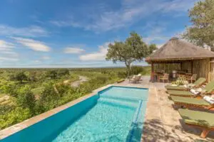 Cool off with a dip in the swimming pool overlooking the bush.
