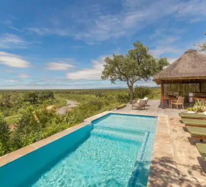 Cool off with a dip in the swimming pool overlooking the bush.